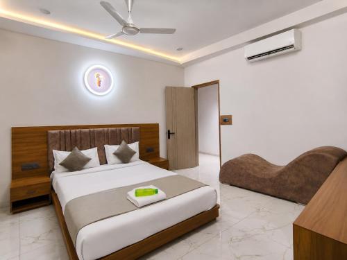 a bedroom with a large bed and a desk at Hotel Elite in Ahmedabad