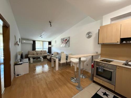 a kitchen and living room with a couch and a table at Aspen Luxury Apartament in Razlog