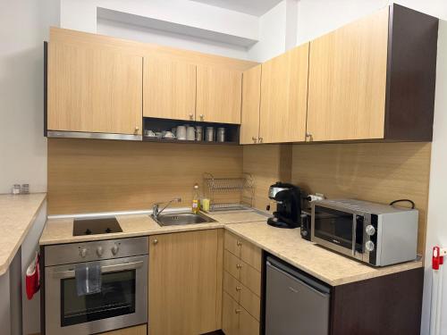 a kitchen with a sink and a microwave at Aspen Luxury Apartament in Razlog