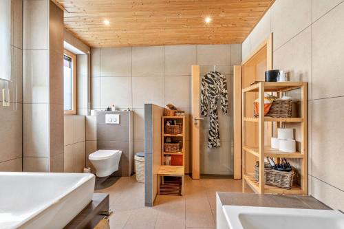 a bathroom with a tub and a toilet and a sink at Ferienwohnung Laura in Illertissen