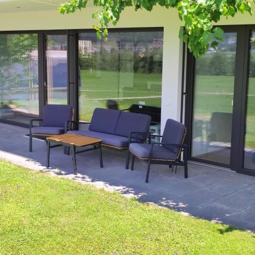 a group of chairs and a table in front of a building at Apart Loris in Hart im Zillertal