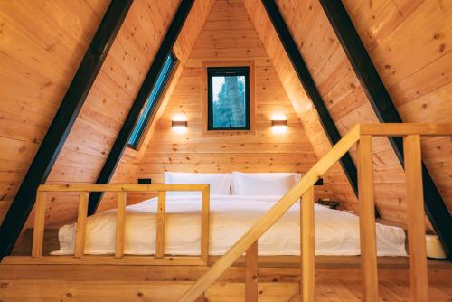 a bedroom in a log cabin with a bed in it at YEYU Hotel in Dujiangyan