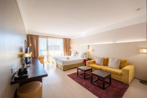 a hotel room with a bed and a couch at Barcelo Royal Beach - All Inclusive in Sunny Beach