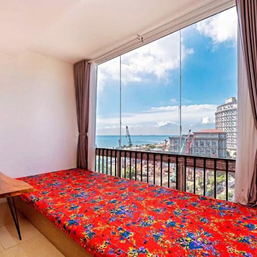 a bedroom with a large window with a view of the ocean at Simpsons homestay - Oasky 36 #viewtamthang #viewbien #vungtau in Xã Thang Tam