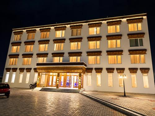 a large white building with a lit up facade at night at Hotel Dekiling by Eastlynn Collections in Leh