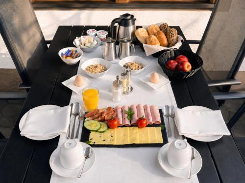 a table with a plate of food on it at Gästehaus Zoller - Rettenberg im Allgäu in Rettenberg