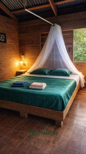 a bedroom with a bed with a mosquito net at Bambou cabane intimiste in Saint-Louis