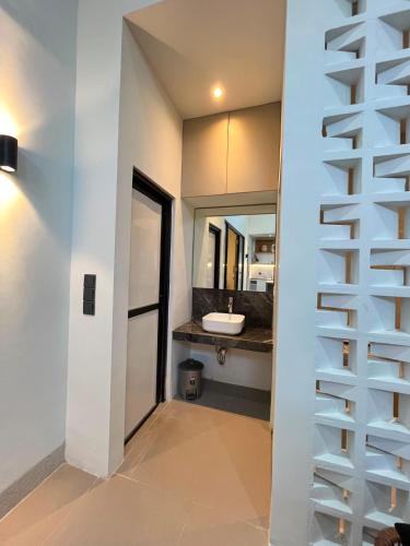 a staircase leading to a bathroom with a sink at Kuraya Urban Space in Surabaya