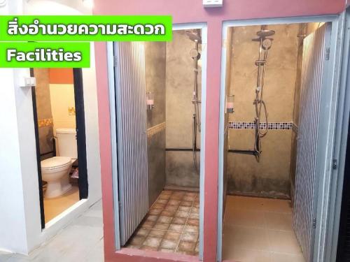 a bathroom with a shower with a glass door at The 25 Hostel in Sathani Khlong Rian