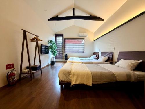 a large bedroom with two beds and a window at ura Kyunoju in Okayama