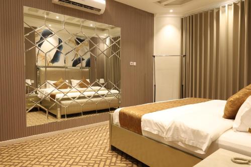 a bedroom with a bed and a soccer display at إطلالة السيب للشقق المخدومة Itlalat Alseeb Serviced Apartments in Khafji