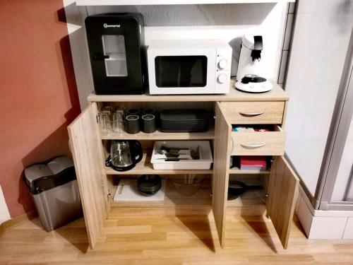 a small kitchen with a microwave on top of it at Pension am Kirchberg - Zimmer 1 in Daun