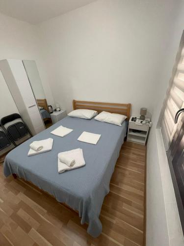 a bedroom with a bed with two towels on it at Anita room in Kotor