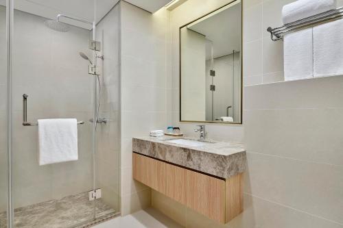 a bathroom with a sink and a shower at Hyatt Place Shanghai Lingang in Zhenghai