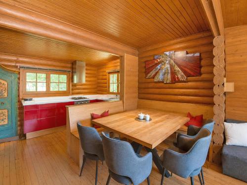 a dining room with a wooden table and chairs at Chalet in Wörgl near Ski Lift in Hopfgarten im Brixental