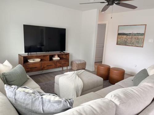 a living room with a couch and a flat screen tv at Remodeled 4BR 2BA Steps from Georgetown Square in Georgetown