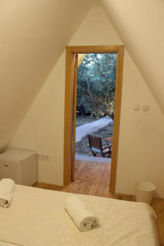 a bedroom with a bed and a door to a patio at Bungalov B in Sveti Filip i Jakov