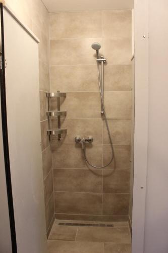 a shower with a hose in a bathroom at Bungalov B in Sveti Filip i Jakov