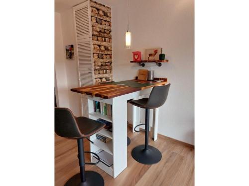 a desk with two chairs and a table in a room at Ferienglück Unterkirnach in Unterkirnach