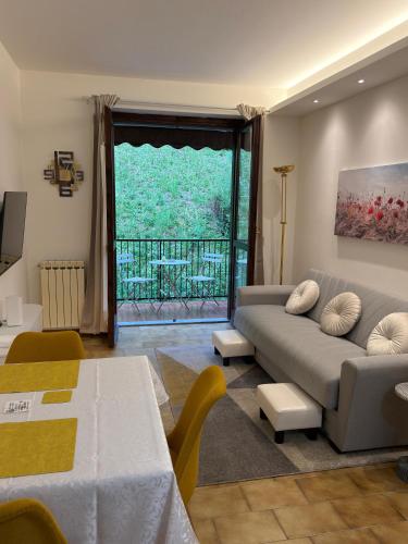 a living room with a couch and a table at Frenk house over Varenna in Perledo