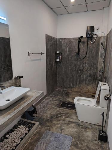 a bathroom with a toilet and a sink at Dothalu Villa in Ahangama