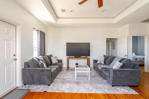 a living room with two couches and a flat screen tv at 3 King Suites 15 Guests - Sunzout in Bolivar Peninsula