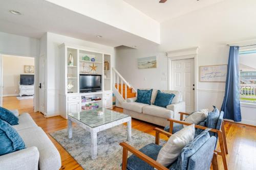 a living room with a couch and a table at 3 King Suites 15 Guests - Sunzout in Bolivar Peninsula