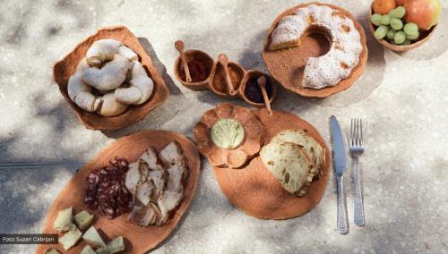 a bunch of different types of food on plates at Josefina unique hotel, adult only in Kozina