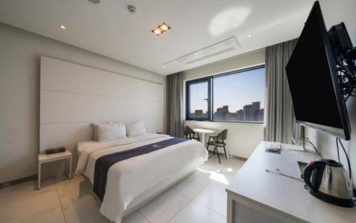 Vuode tai vuoteita majoituspaikassa Ansan Rosabell Hotel