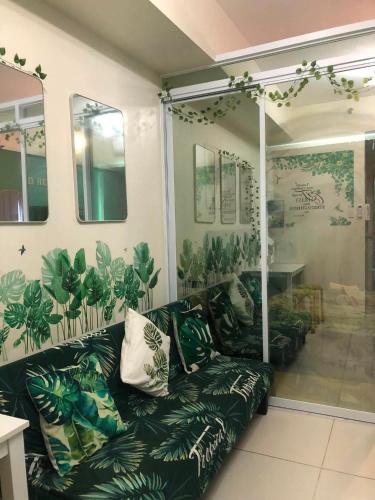 a living room with a couch and plants on the walls at Escapade in Tagaytay by JV in Kaybagal