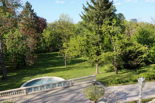 a view of a park with trees and a fence at Seminarhotel Springer Schlössl in Vienna