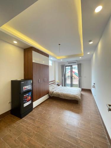 a bedroom with a bed and a tv in a room at 25House Cozy Apartment near West Lake & Airport in Hanoi