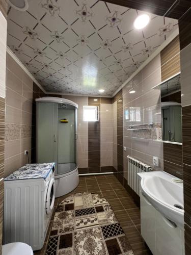 a bathroom with a toilet and a sink and a tub at Sultan in Kochkorka