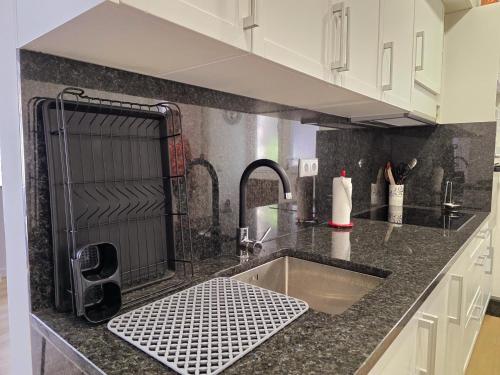 a kitchen with a sink and a counter top at Cantinho da Muralha in Melgaço