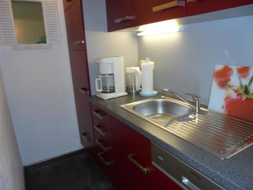 a kitchen counter with a sink and a coffee maker at Ostseestern in Damp