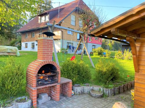 a brick oven in a yard in front of a house at Süßen Häusle in Breitnau