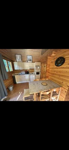 a view of a kitchen with a table in a cabin at Chalet 2 chambres à Estavar in Estavar
