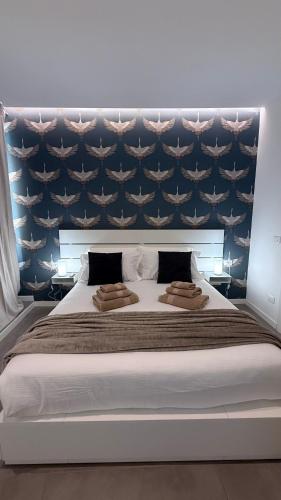 a bedroom with a large bed with two pillows at CR Home in Palermo