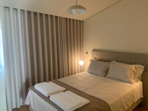 a bedroom with a bed with two white pillows at Sol 41 in Bragança
