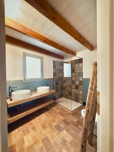 a bathroom with a glass shower and a sink at Corte CeLestiale in Albenga