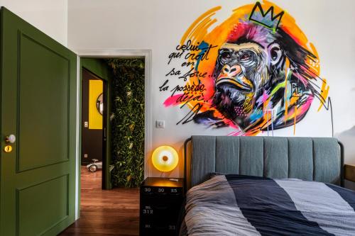 a bedroom with a large painting of a gorilla on the wall at Le Duval 66 in Pontarlier