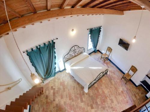a living room with a white couch and stairs at Corte CeLestiale in Albenga