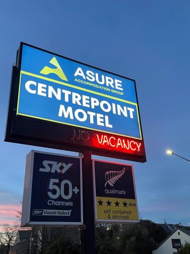 a sign for a centurion motel on the side of a store at ASURE Centrepoint Motel in Christchurch