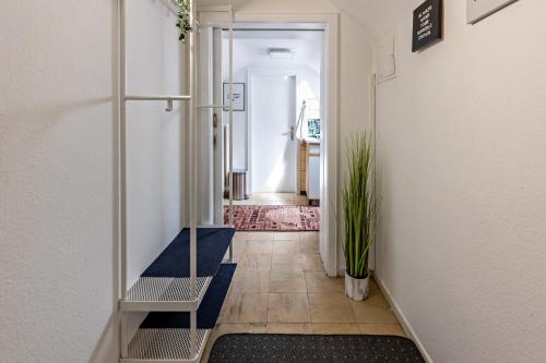 a hallway with a blue bench and a plant at Ferienappartement Sonnenhof in Triberg
