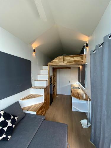 a room with a bed and a desk and stairs at Beach Access Tiny House 06 - Lipa Noi Beach in Koh Samui