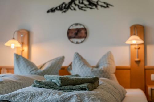 a room with a bed with blue pillows at Apartment BergStyle in Pfronten
