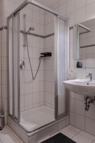 a bathroom with a shower and a sink at Apartment BergStyle in Pfronten