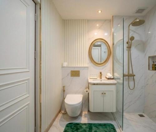a bathroom with a shower and a toilet and a sink at Tak Residence Hotel in Tak