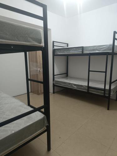 a room with two bunk beds in a room at Urban hostel Saryarka in Astana