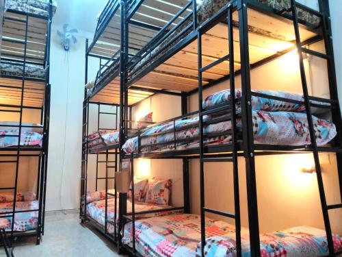 a group of bunk beds in a room at شقق وهوستل قصر الشباب للمصريين و المقيمين فقط Youth Palace Hostel & Apartments for Egyptians & Residents Only in Alexandria